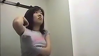 Voyeuristic Footage Of An Asian Woman Changing In A Dressing Room