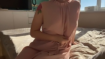 A Sensual Woman Teases Her Intimate Areas In A Soft Pink Dress